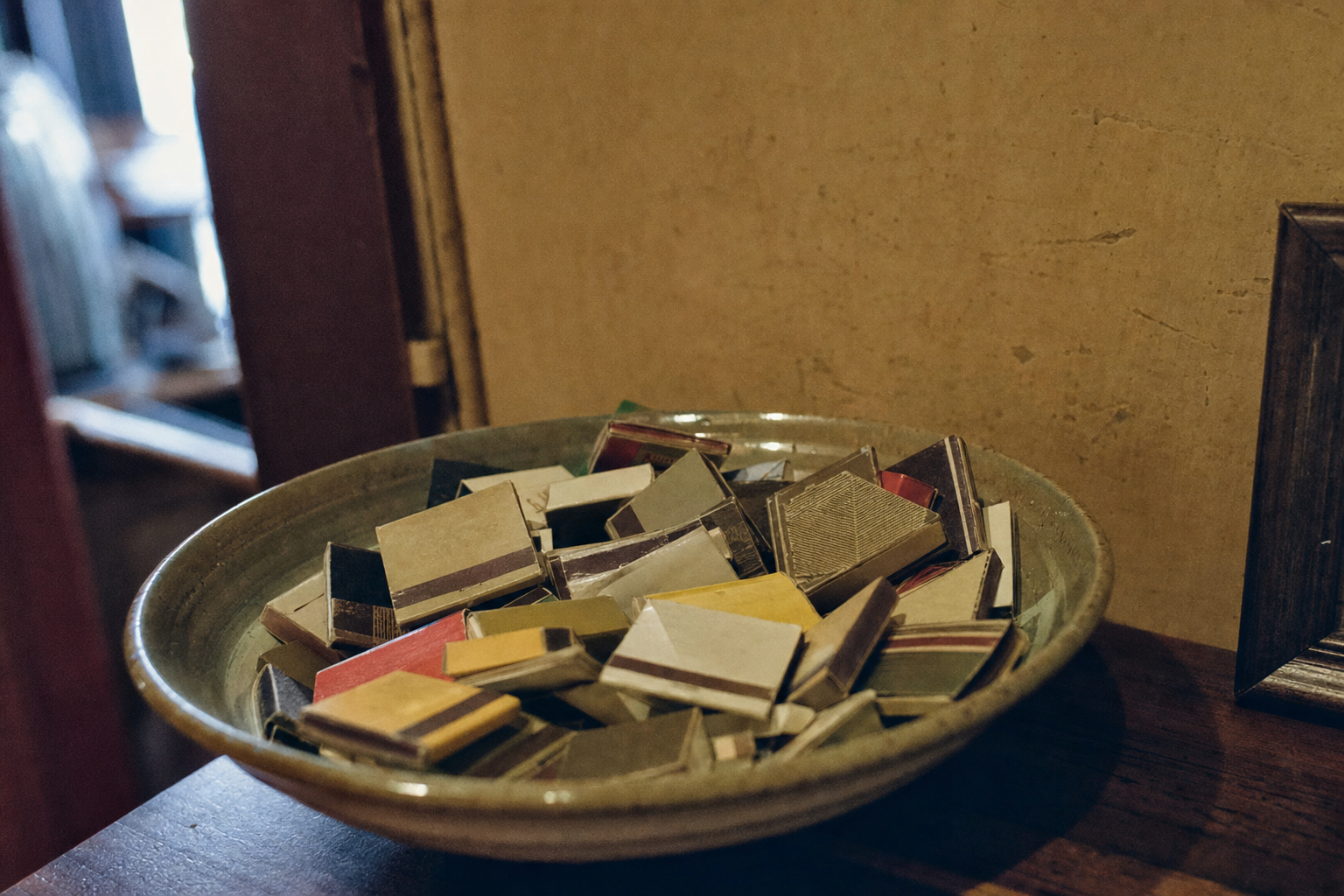 A worn paper matchbook on an ivory surface